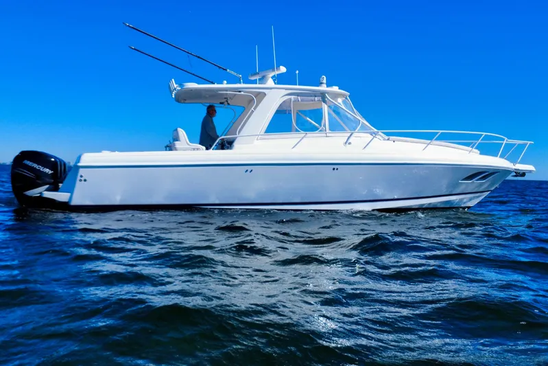  Yacht Photos Pics 2000 Intrepid 377 Walkaround boat on open water under clear blue sky.