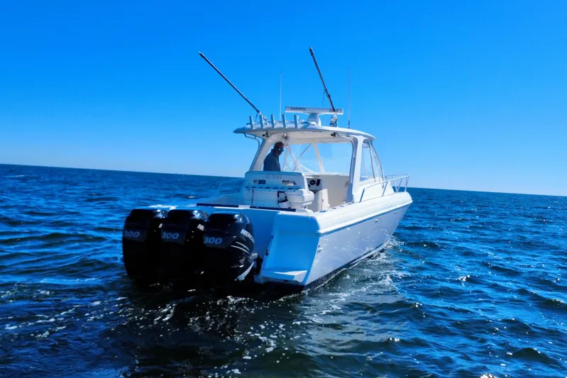  Yacht Photos Pics 2000 Intrepid 377 Walkaround boat cruising on open water under clear blue sky.