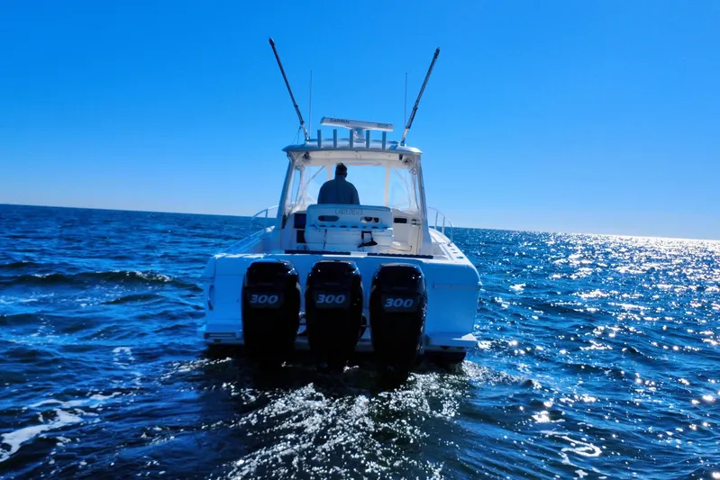  Yacht Photos Pics 2000 Intrepid 377 Walkaround boat cruising on open sea under clear blue sky.