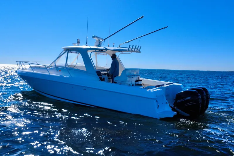 Yacht Photos Pics 2000 Intrepid 377 Walkaround boat on open water, featuring dual Mercury engines.