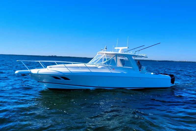  Yacht Photos Pics 2000 Intrepid 377 Walkaround boat on open water under clear blue sky.