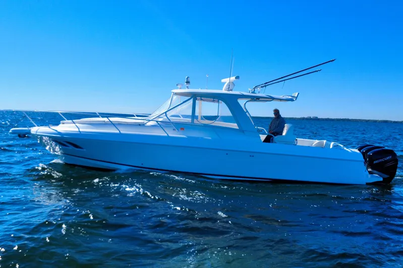  Yacht Photos Pics 2000 Intrepid 377 Walkaround boat cruising on open water under clear blue sky.