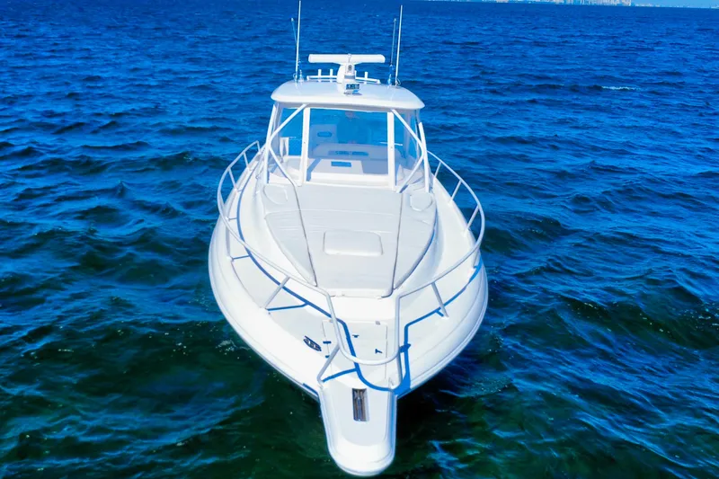  Yacht Photos Pics 2000 Intrepid 377 Walkaround boat on open blue sea.