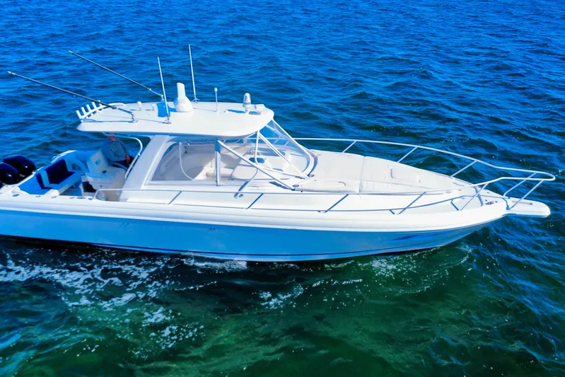  Yacht Photos Pics 2000 Intrepid 377 Walkaround boat cruising on blue ocean waters.