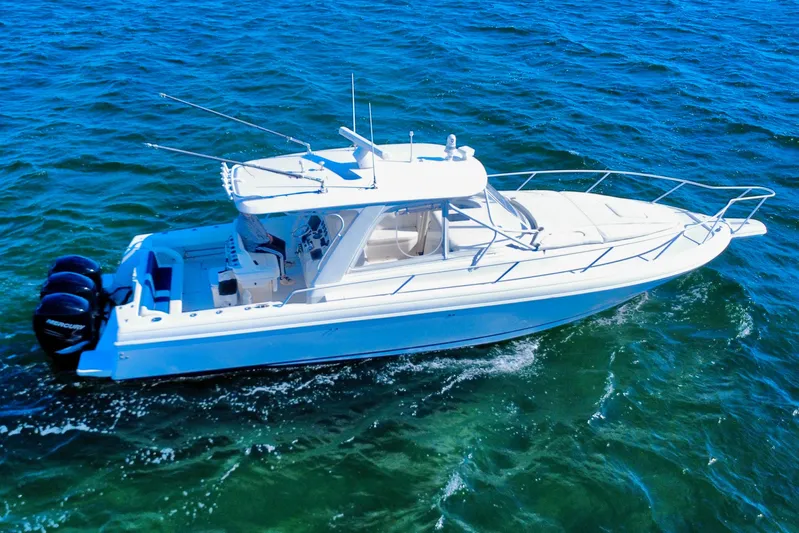  Yacht Photos Pics 2000 Intrepid 377 Walkaround boat cruising on open water, featuring triple Mercury engines.