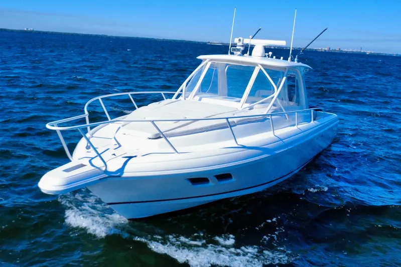  Yacht Photos Pics 2000 Intrepid 377 Walkaround boat cruising on open water under clear blue skies.