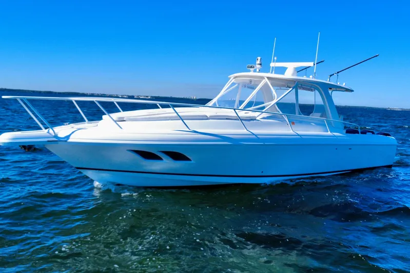  Yacht Photos Pics 2000 Intrepid 377 Walkaround boat cruising on open water under clear blue sky.