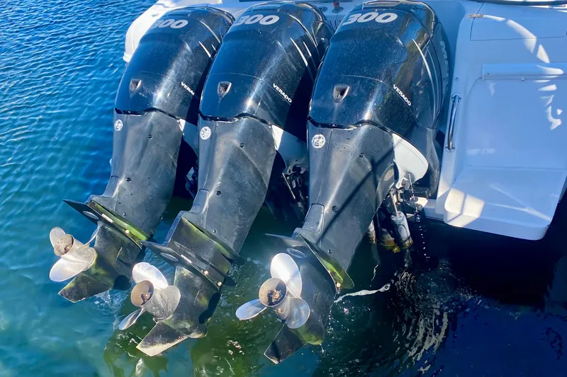  Yacht Photos Pics Triple outboard engines on a 2000 Intrepid 377 Walkaround boat in water.