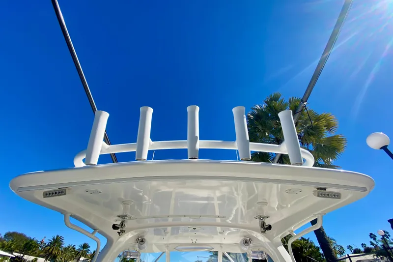  Yacht Photos Pics 2000 Intrepid 377 Walkaround boat with rod holders, under clear blue sky.
