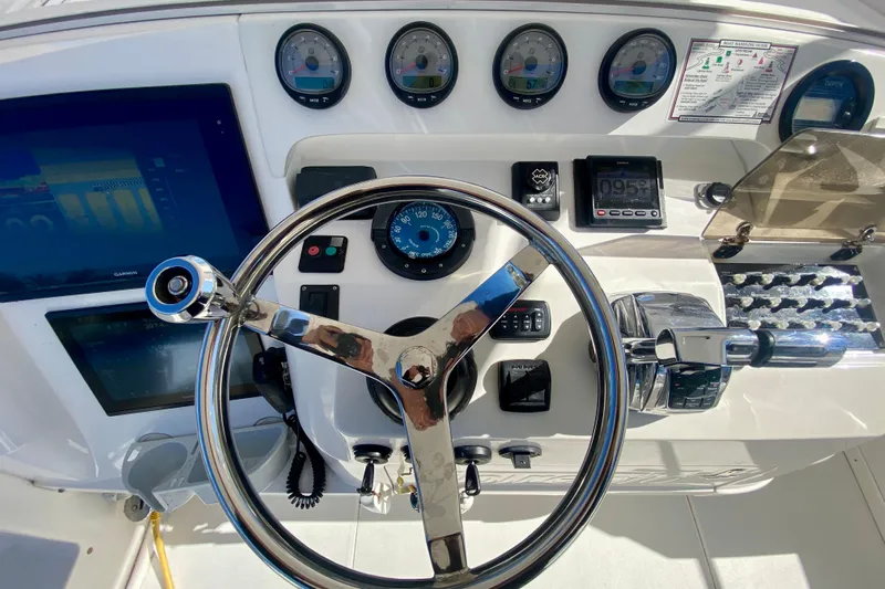  Yacht Photos Pics Control panel of a 2000 Intrepid 377 Walkaround boat with steering wheel and gauges.
