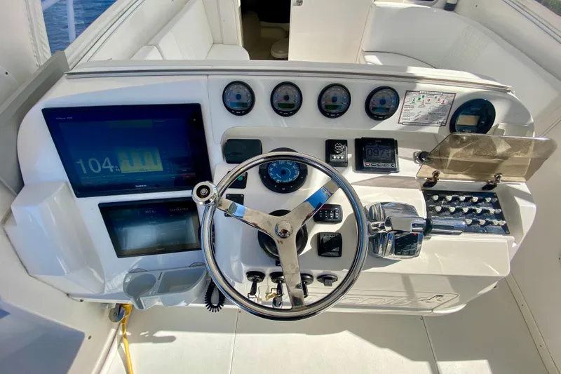  Yacht Photos Pics Control panel of a 2000 Intrepid 377 Walkaround boat with steering wheel and gauges.