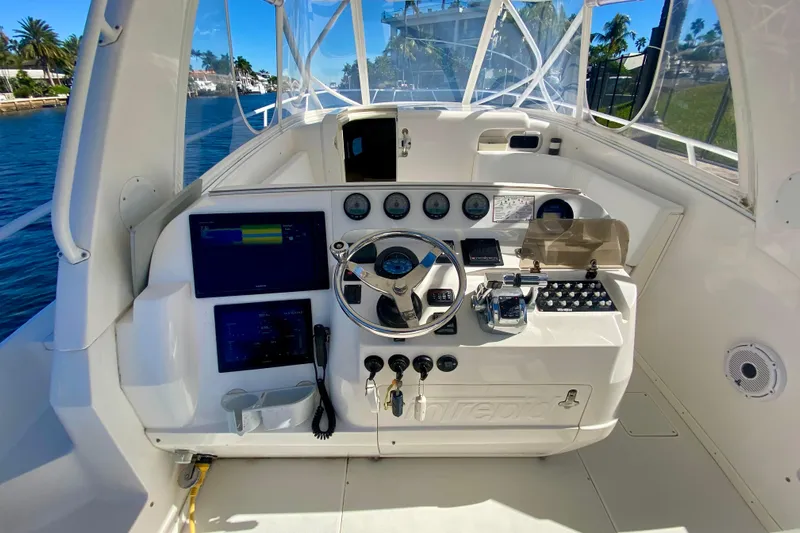  Yacht Photos Pics 2000 Intrepid 377 Walkaround helm with steering wheel, gauges, and navigation screens.