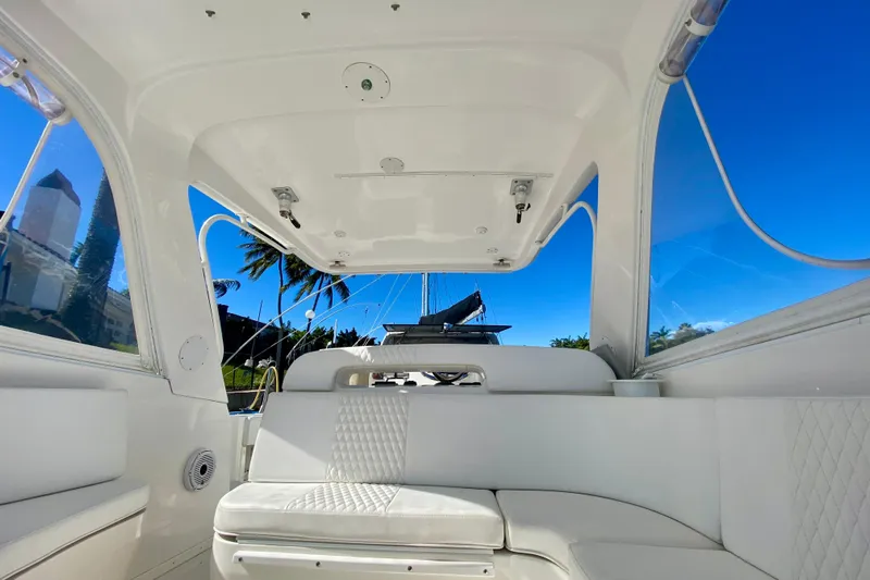  Yacht Photos Pics Interior view of a 2000 Intrepid 377 Walkaround boat with white seating and clear windows.