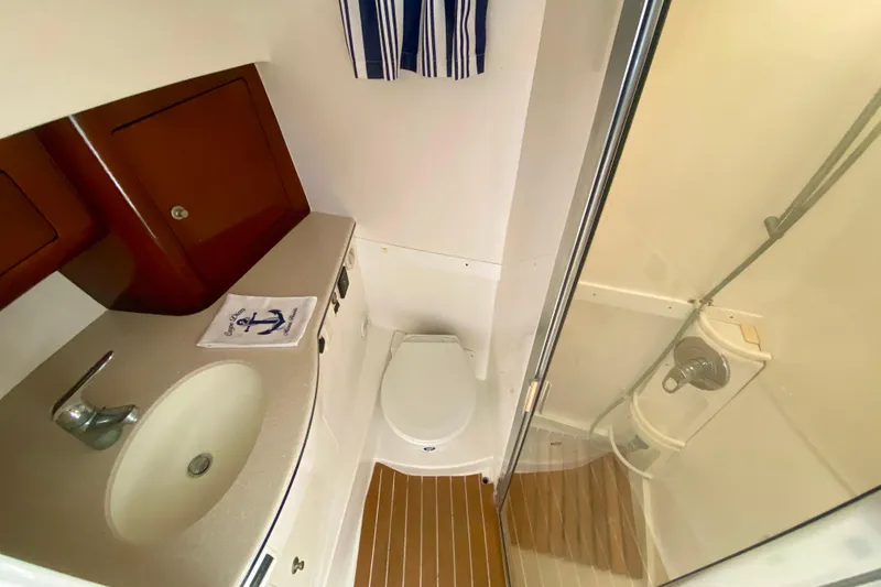  Yacht Photos Pics Bathroom interior of 2000 Intrepid 377 Walkaround with sink, toilet, and shower.