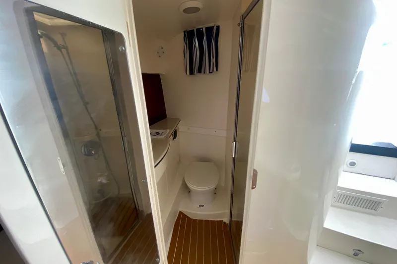  Yacht Photos Pics 2000 Intrepid 377 Walkaround boat bathroom with shower and toilet.