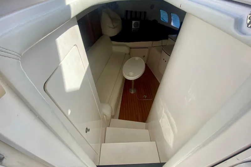  Yacht Photos Pics Interior of 2000 Intrepid 377 Walkaround boat with seating and table.