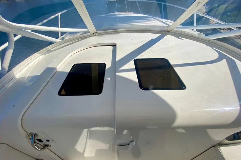  Yacht Photos Pics 2000 Intrepid 377 Walkaround boat deck with hatches, overlooking water.