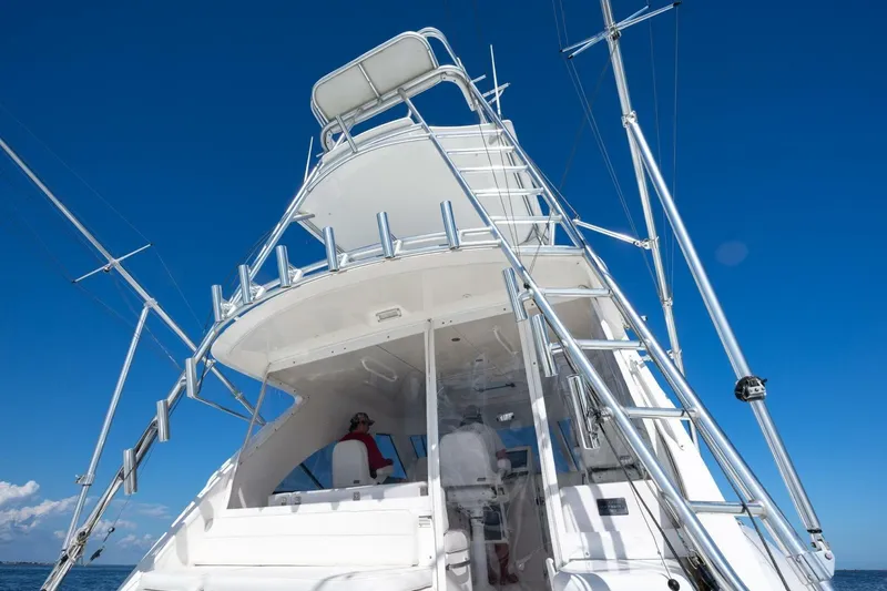 True Story Yacht Photos Pics 2012 Cabo 40 Hardtop Express yacht with tower against clear blue sky.