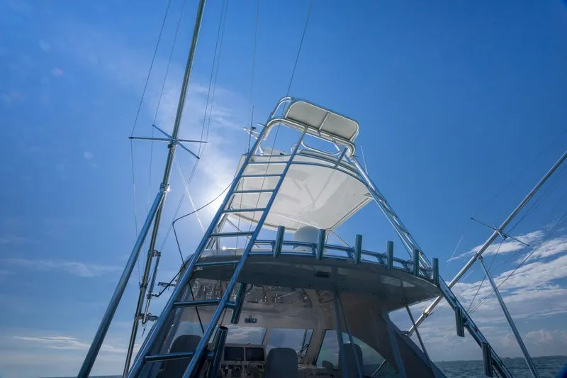 True Story Yacht Photos Pics 2012 Cabo 40 Hardtop Express yacht under clear blue sky, viewed from below.