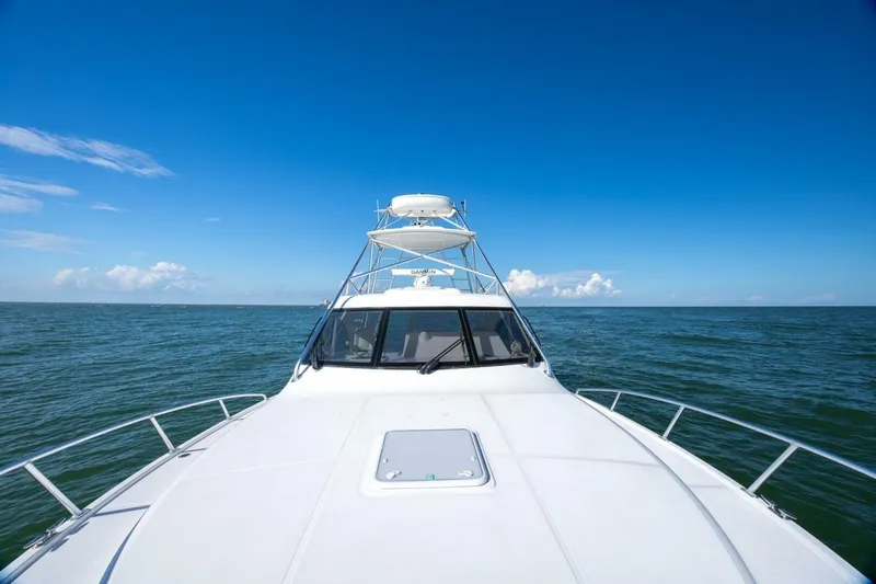 True Story Yacht Photos Pics 2012 Cabo 40 Hardtop Express yacht cruising on open sea under clear blue sky.