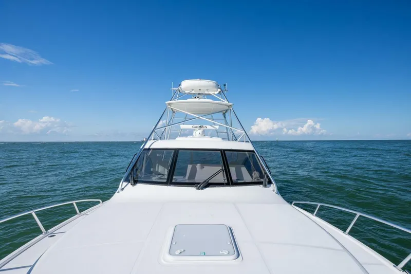 True Story Yacht Photos Pics 2012 Cabo 40 Hardtop Express yacht cruising on open sea under clear blue sky.