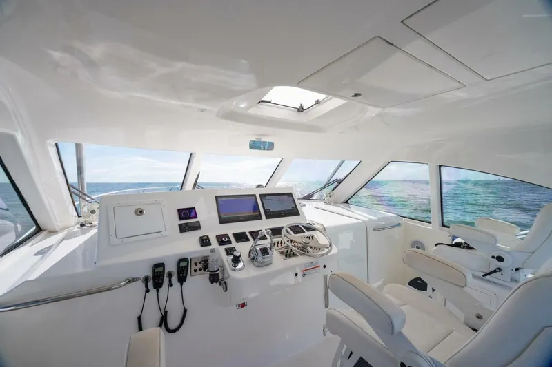 True Story Yacht Photos Pics 2012 Cabo 40 Hardtop Express yacht helm with ocean view and modern controls.