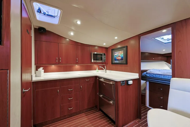 True Story Yacht Photos Pics Luxurious interior of 2012 Cabo 40 Hardtop Express yacht with modern kitchen and cozy cabin.