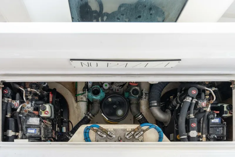 True Story Yacht Photos Pics Engine compartment of a 2012 Cabo 40 Hardtop Express boat, showcasing mechanical components.