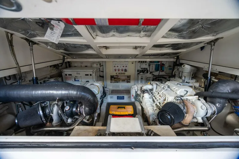 True Story Yacht Photos Pics Engine room of 2012 Cabo 40 Hardtop Express, showcasing dual engines and mechanical components.