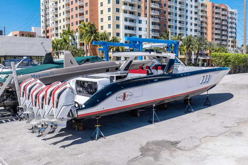  Yacht Photos Pics 2021 Cigarette 59 Tirranna boat with multiple engines, parked near high-rise buildings.