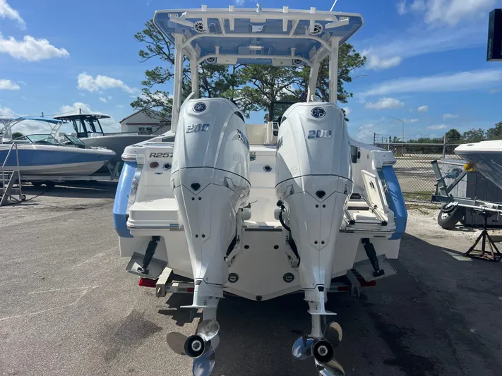 Yacht Photos Pics 2025 Robalo R257 Dual Console boat with twin 300 horsepower engines, parked outdoors.