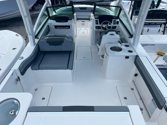  Yacht Photos Pics 2025 Robalo R257 Dual Console boat interior with seating, steering wheel, and storage compartments.