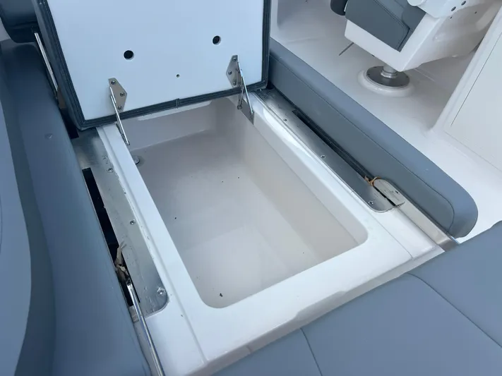  Yacht Photos Pics 2025 Robalo R257 Dual Console boat storage compartment, open and empty.