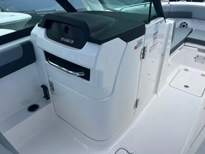  Yacht Photos Pics 2025 Robalo R257 Dual Console boat interior with storage compartment and seating area.