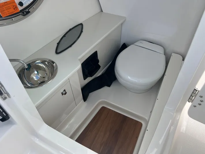  Yacht Photos Pics 2025 Robalo R257 Dual Console boat bathroom with sink and toilet.