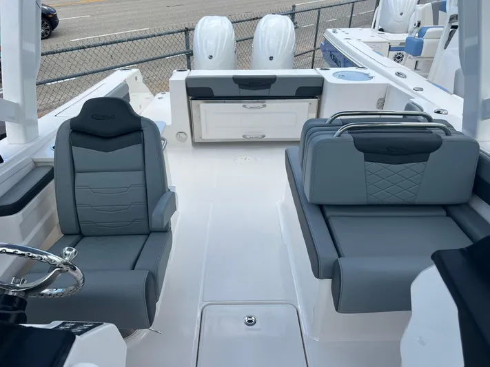  Yacht Photos Pics 2025 Robalo R257 Dual Console boat interior with gray seating and dual engines.