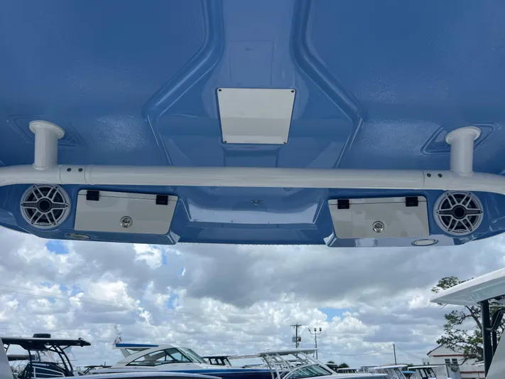  Yacht Photos Pics 2025 Robalo R257 Dual Console boat speakers and canopy against a cloudy sky.