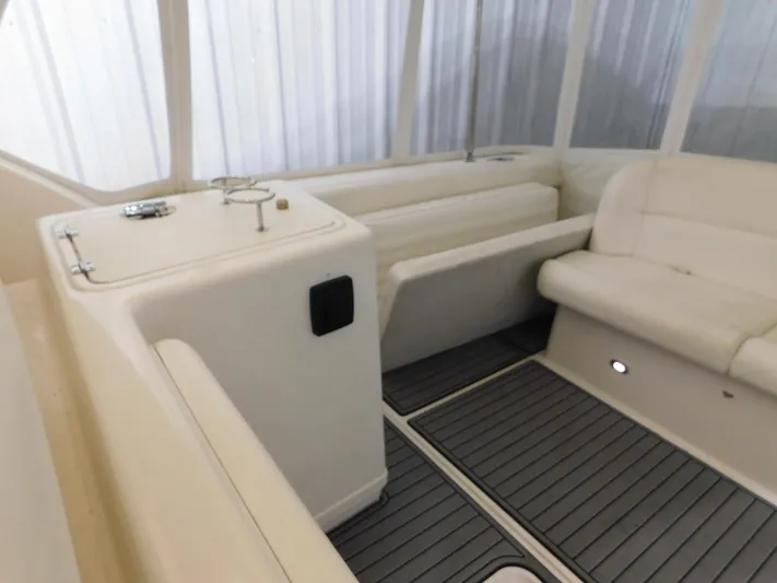 Sun Baked Yacht Photos Pics 1999 Tiara Yachts 3500 Express interior with white seating and sleek flooring.