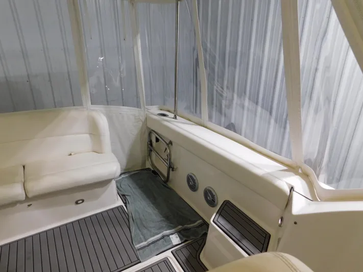 Sun Baked Yacht Photos Pics 1999 Tiara Yachts 3500 Express interior with white seating and clear enclosure.
