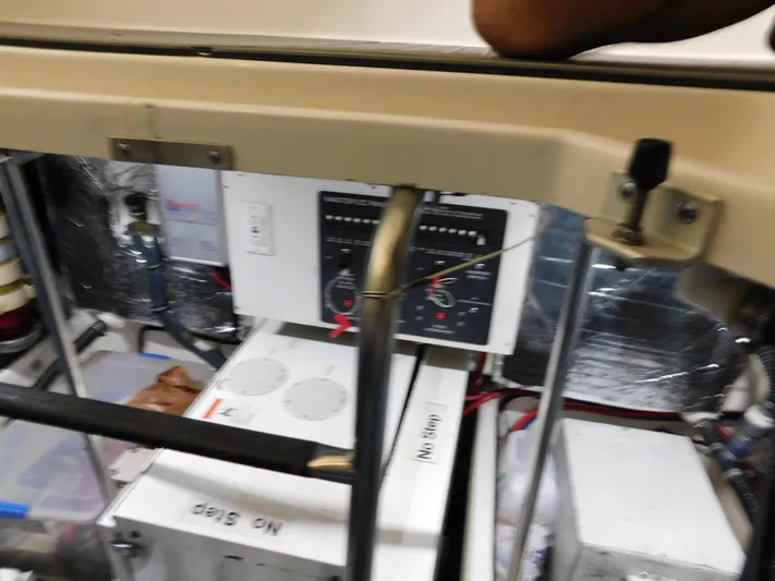 Sun Baked Yacht Photos Pics Engine room of a 1999 Tiara Yachts 3500 Express, showing control panels and equipment.