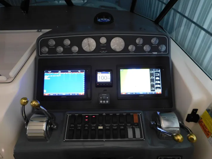 Sun Baked Yacht Photos Pics 1999 Tiara Yachts 3500 Express dashboard with navigation screens and controls.