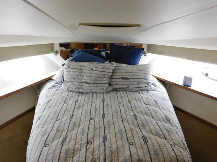 Sun Baked Yacht Photos Pics 1999 Tiara Yachts 3500 Express cabin interior with cozy bed and nautical decor.