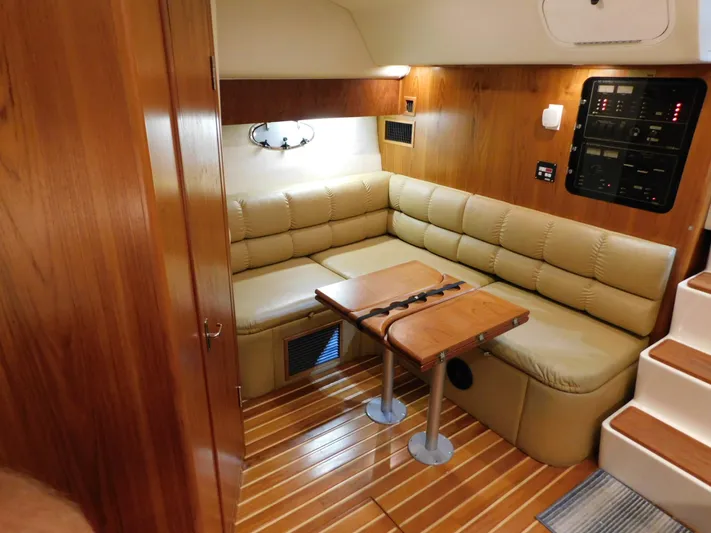 Sun Baked Yacht Photos Pics 1999 Tiara Yachts 3500 Express interior with beige seating and wooden accents.