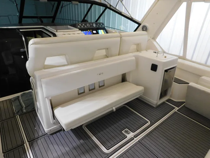 Sun Baked Yacht Photos Pics 1999 Tiara Yachts 3500 Express interior with white seating and modern dashboard.