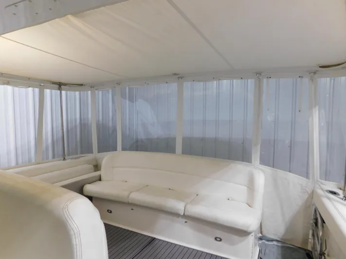 Sun Baked Yacht Photos Pics 1999 Tiara Yachts 3500 Express interior with white seating and enclosed cabin.