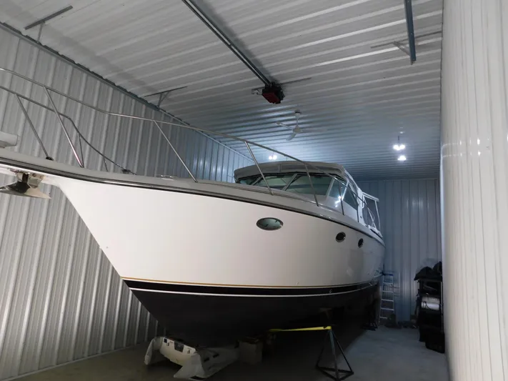 Sun Baked Yacht Photos Pics 1999 Tiara Yachts 3500 Express stored in a metal-walled indoor facility.