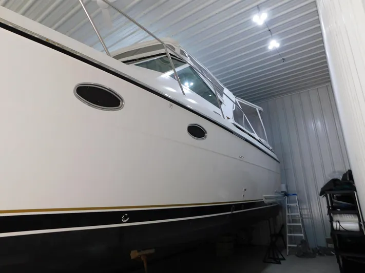 Sun Baked Yacht Photos Pics 1999 Tiara Yachts 3500 Express in storage, side view with sleek design.