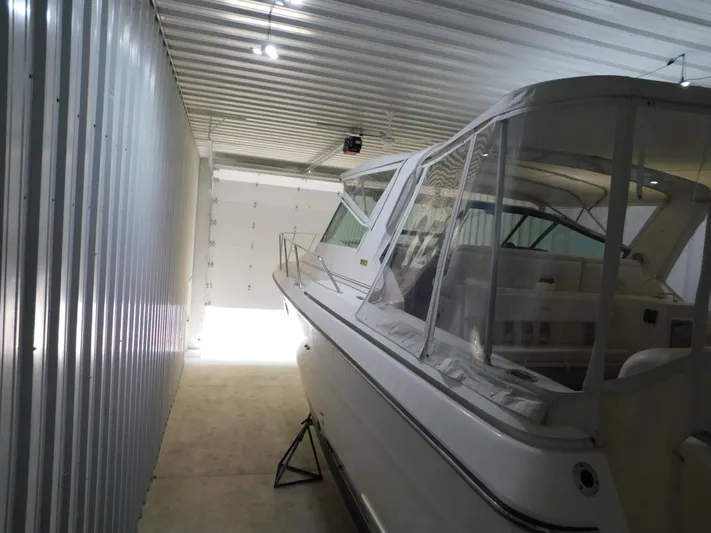 Sun Baked Yacht Photos Pics 1999 Tiara Yachts 3500 Express stored in a metal garage.
