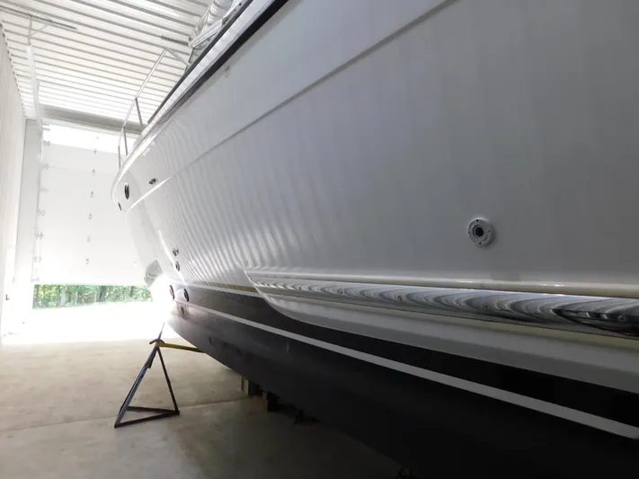 Sun Baked Yacht Photos Pics 1999 Tiara Yachts 3500 Express in storage, side view of hull and sleek design.