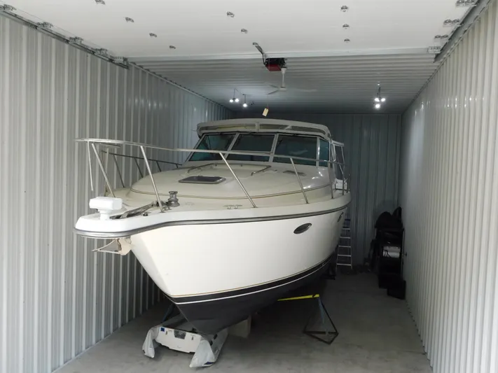 Sun Baked Yacht Photos Pics 1999 Tiara Yachts 3500 Express stored in a metal garage.